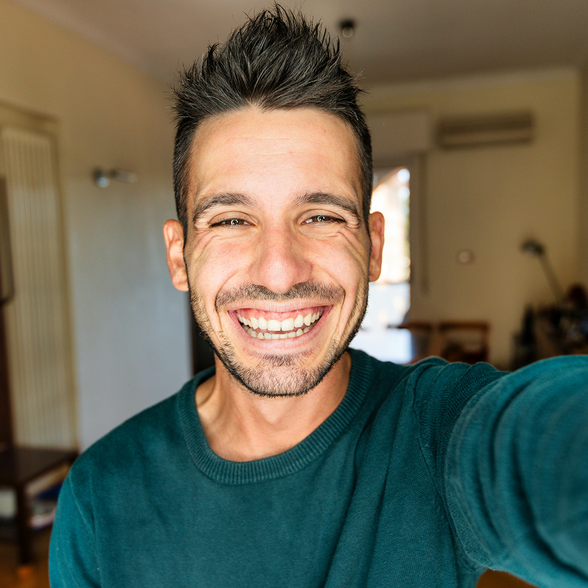happy man taking selfie in home