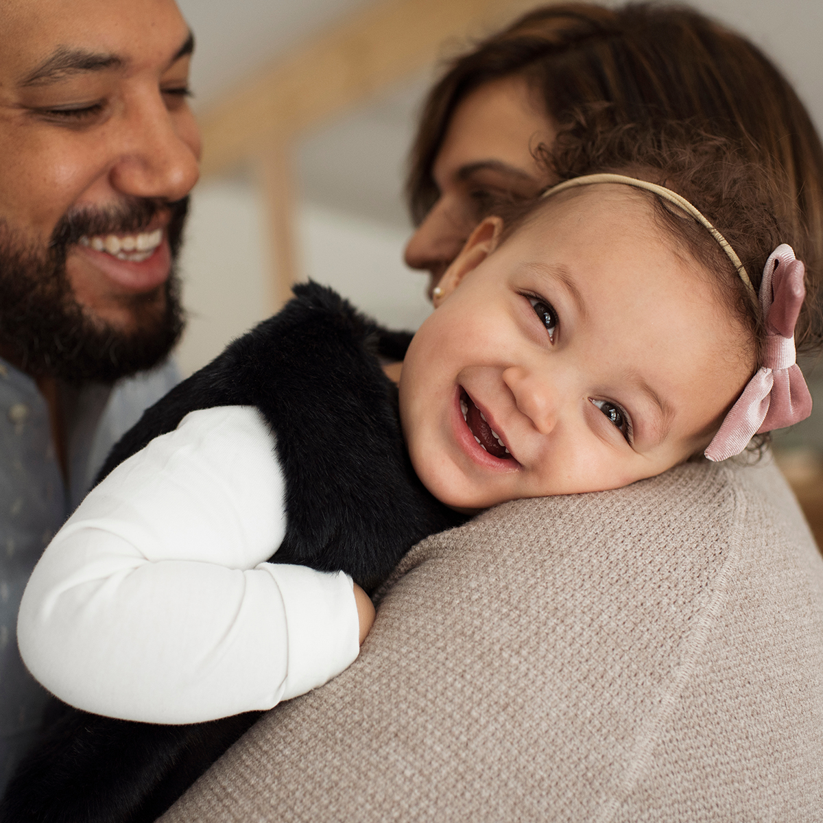 attentive father with mother holding their daughter