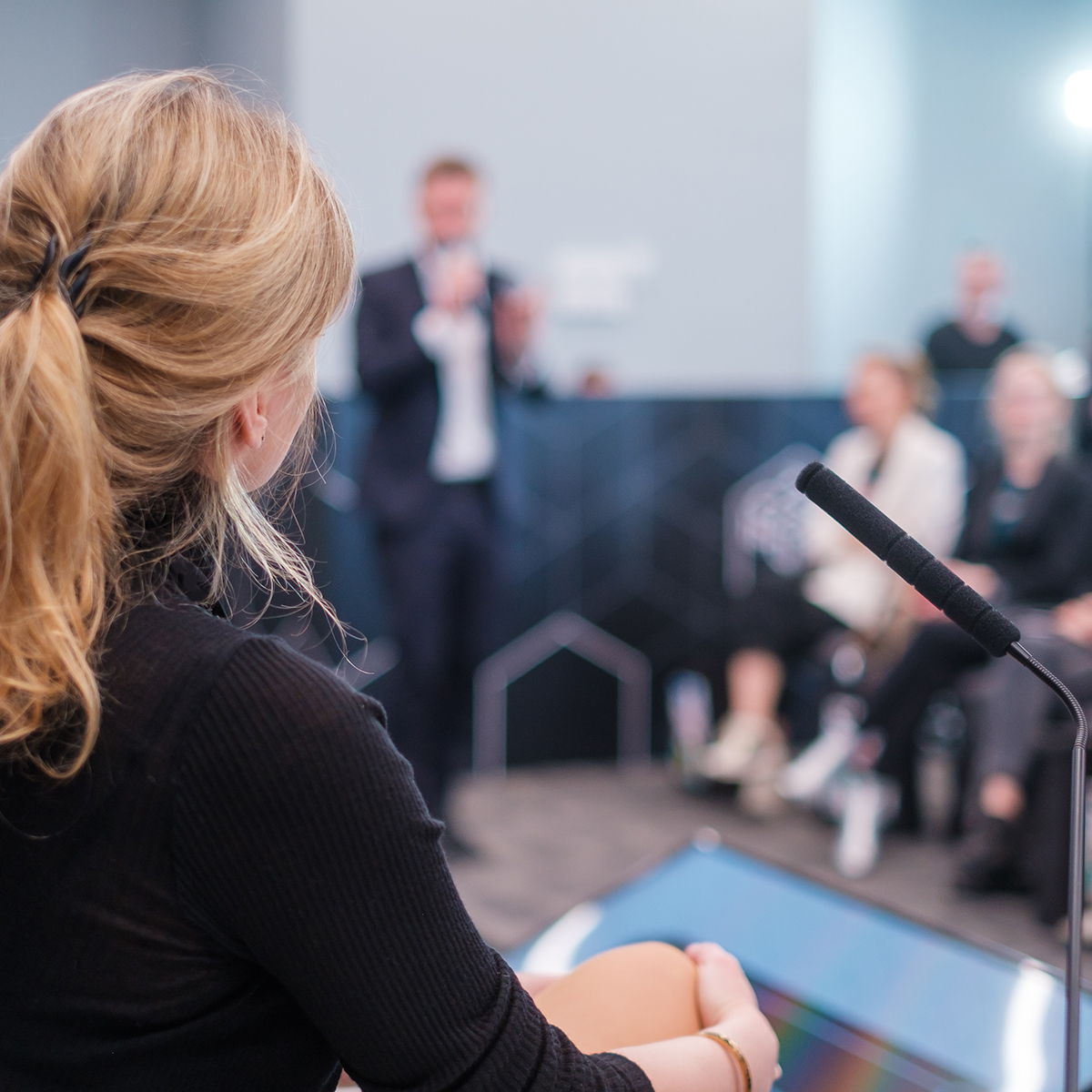 female speaker giving a presentation