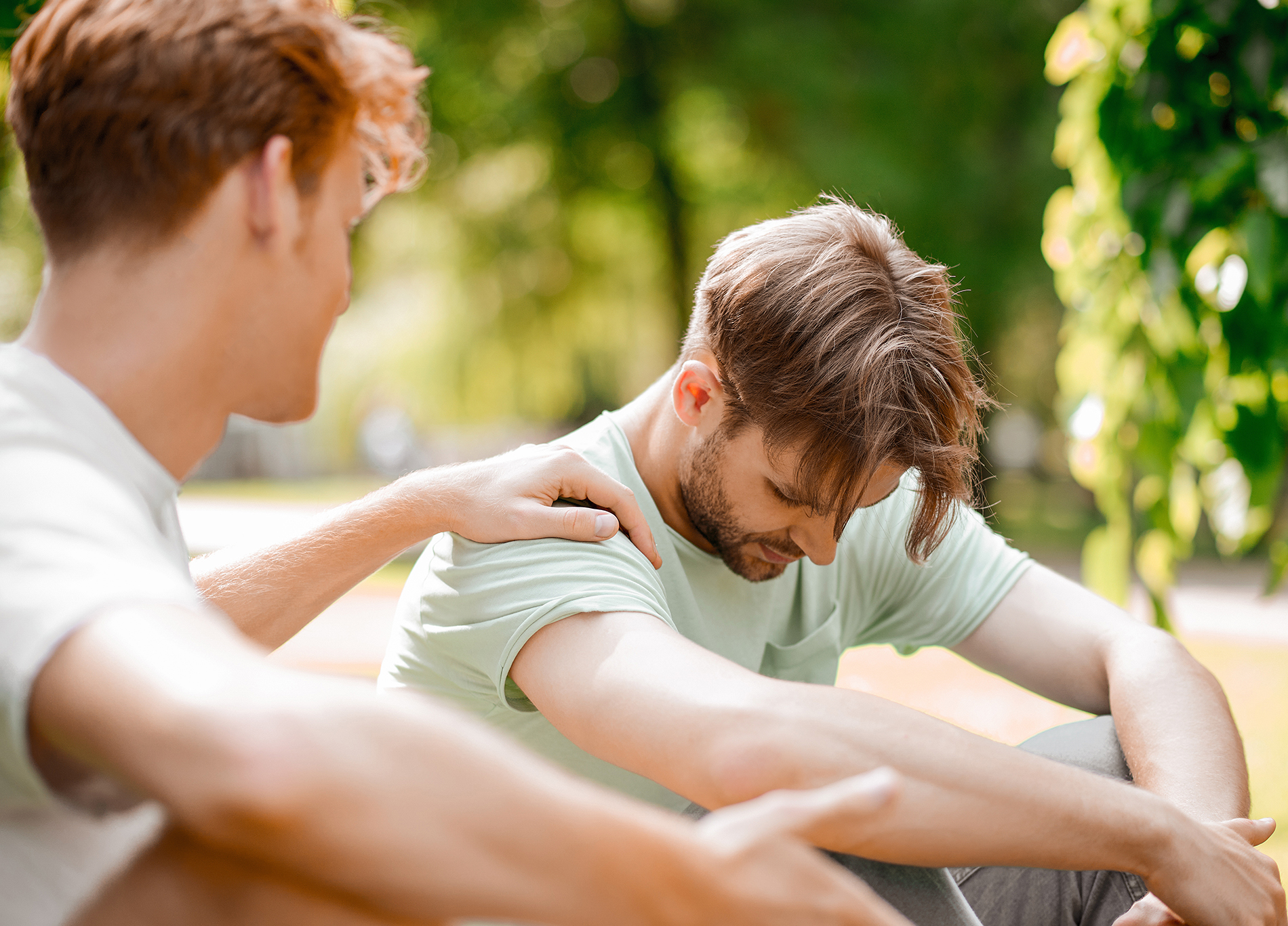 Sad man being comforted by a friend